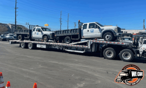 Two Ford F-550s loaded on a step deck for transport