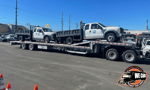 Two Ford F-550s loaded on a step deck for transport