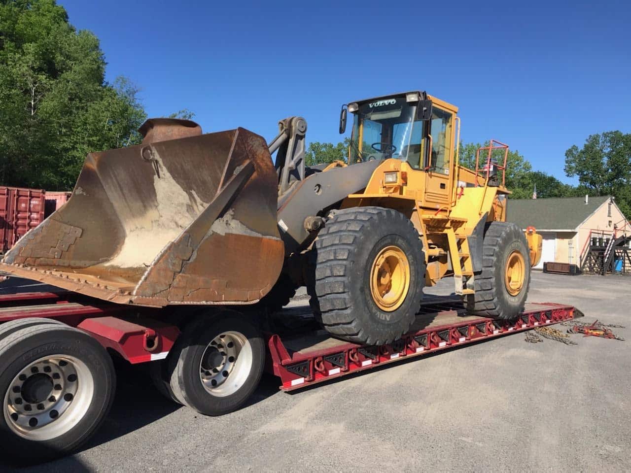hauling yellow volvo machine