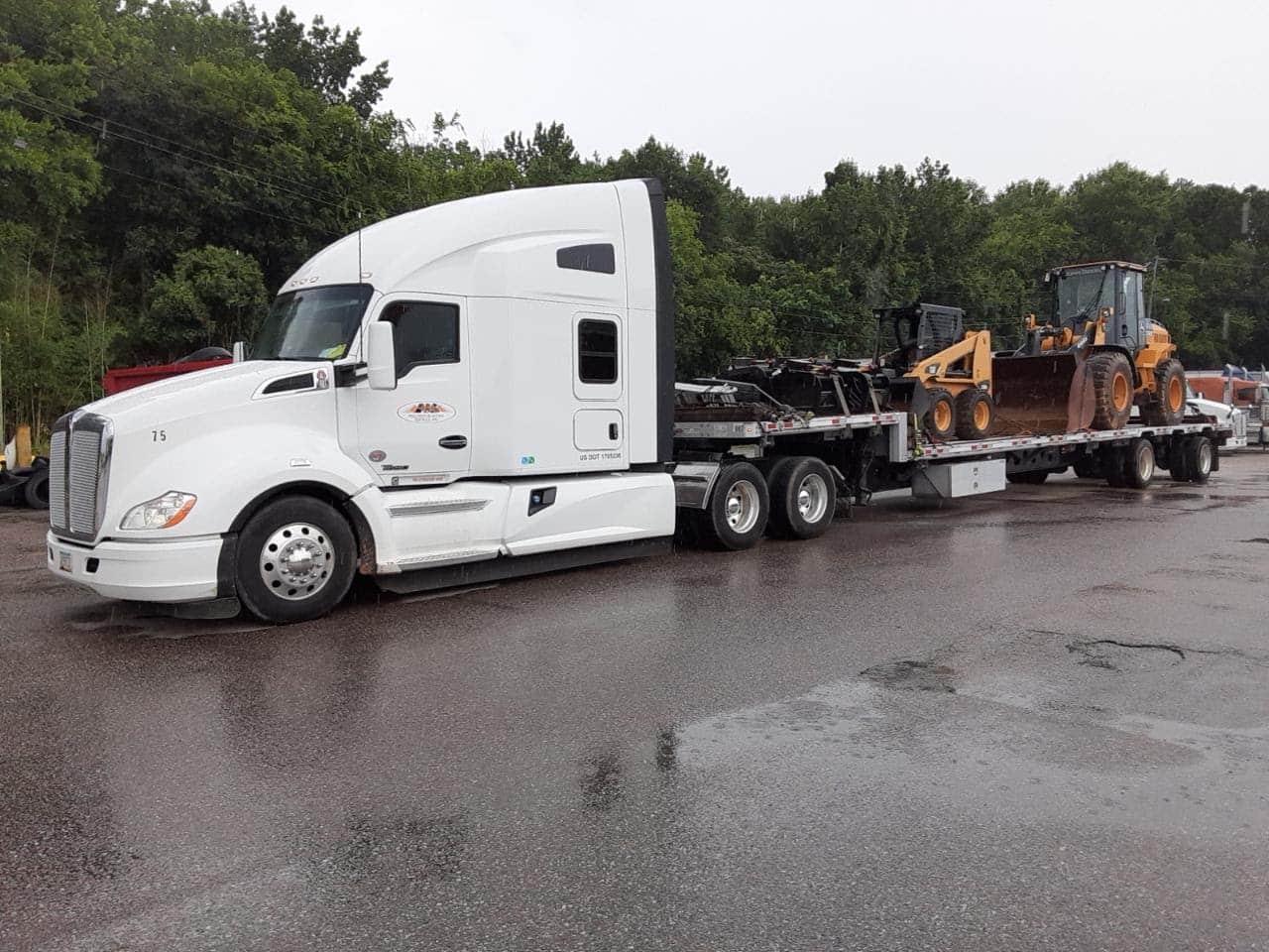 white truck hauling machines
