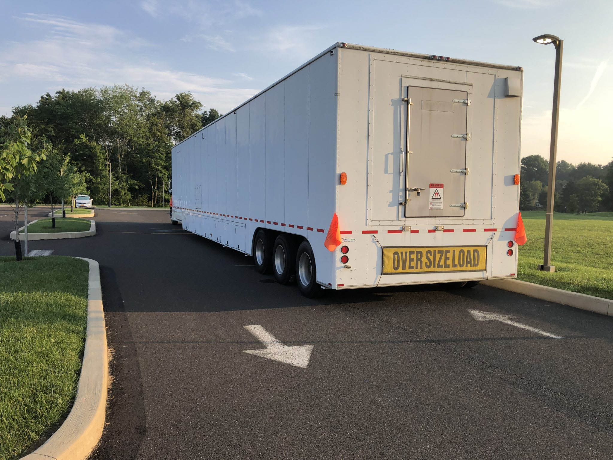 white oversized load truck