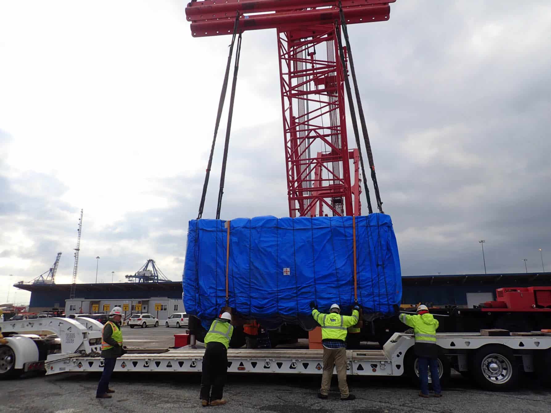men loading wrapped container